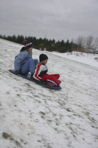 Sisters Kaitlyn and Sarah Van Cise of Snoqualmie barrell down “Kite Hill” at Snoqualmie Ridge Community Park on Tuesday afternoon