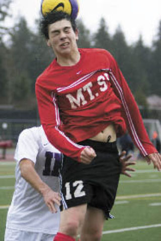 Mount Si’s Kyle Bauman head-butts the ball during play