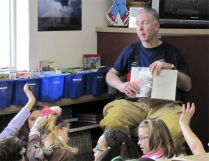 Snoqualmie volunteer firefighter Steve Stockman reads to children during the Badges and Books outreach by local emergency responders