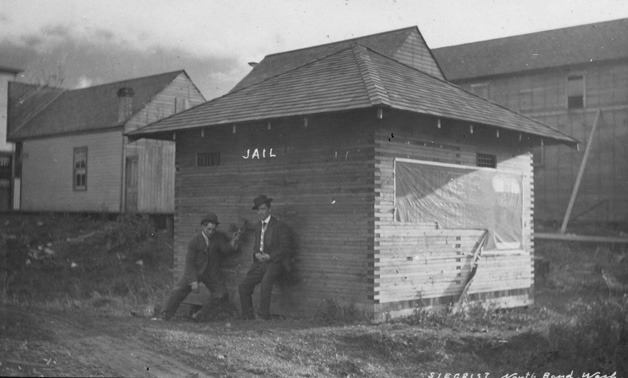 Two men linger by the North Bend jailhouse circa 1910.