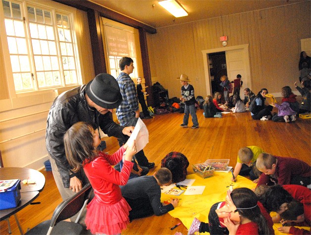 A youngster shows her drawing to Michael Bodwick