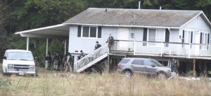 Valley (South County) SWAT team members move around a flood-damaged Fall City house during a practice session Thursday. They practiced basic techniques used in entering buildings.