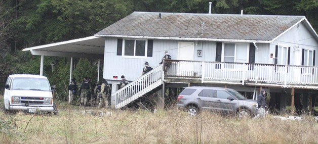 Valley (South County) SWAT team members move around a flood-damaged Fall City house during a practice session Thursday. They practiced basic techniques used in entering buildings.