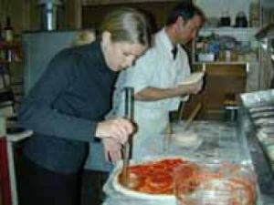 Pizza man tosses east coast style pies