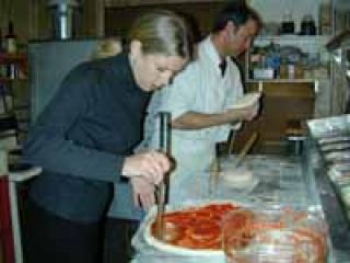 Pizza man tosses east coast style pies