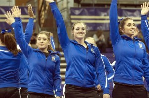 San Jose freshman Cami Guyer waves to the crowd with teammates during a three-way meet at the University of Washington on March 9.
