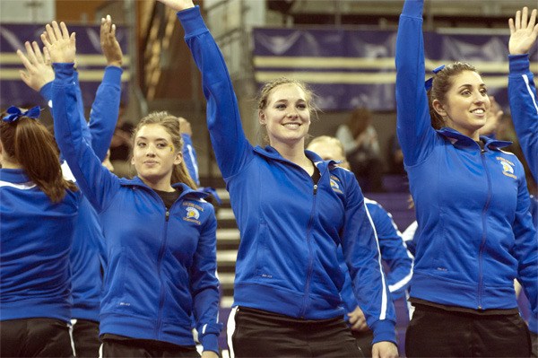 San Jose freshman Cami Guyer waves to the crowd with teammates during a three-way meet at the University of Washington on March 9.