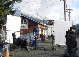 Cast and crew members from “Lucky Them” exit the Mount Si Pub for another take of a scene that begins in the car outside. The film crew spent most of a day filming at North Bend’s Mount Si Pub