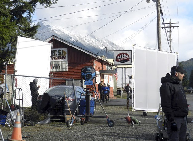 Cast and crew members from “Lucky Them” exit the Mount Si Pub for another take of a scene that begins in the car outside. The film crew spent most of a day filming at North Bend’s Mount Si Pub