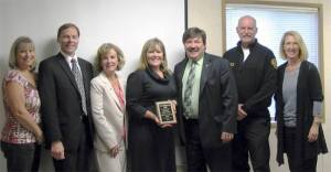 Presenting the Community Service Award to the Linnerooth Team