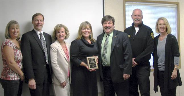 Presenting the Community Service Award to the Linnerooth Team