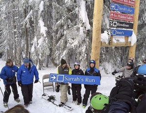 Holding the sign for Summit East's new ski run are Sarrah Powers' brother