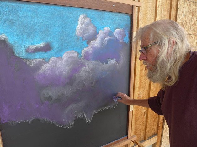 Market artist Joe Lee Davidson works on a chalk drawing on a portion of the new Arts Booth at Carnation Farmer’s Market. The market ends October 29.