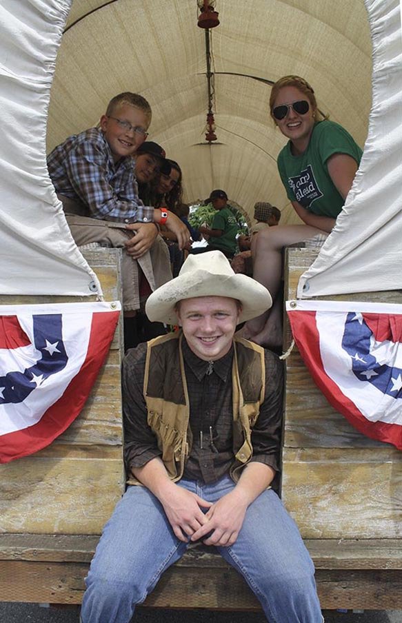 A covered wagon makes an ideal float for the 2014 Carnation Fourth of July parade.