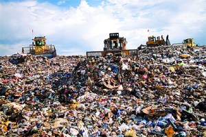 Bulldozers compact trash at Cedar Hills Regional Landfill in Maple Valley. Families can slow the filling of the landfill and prevent carbon emissions by recycling more.