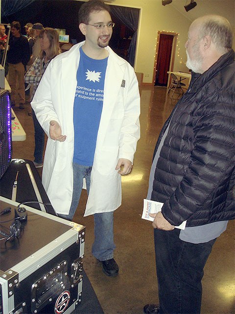 Brandon Comouche talks with a visitor at the May 16 DIY and Hackers Showcase event at the Sallal Grange in North Bend.