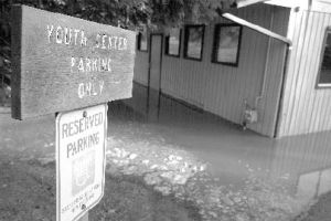 Sewage inside the Snoqualmie Valley Youth Activity Center in North Bend was several inches deep after a sewage plant nearby overflowed Saturday