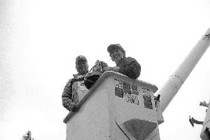 Steven Walter of Tanner Electric and St. Clare of Assisi Pastor Patty Baker recover the 65-pound bell from the tower of the Snoqualmie church. Reclaiming the bell was one of the final tasks that needed to be done before the moldy and flood-damaged church can be demolished this spring.