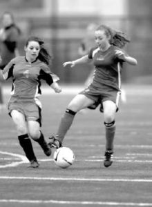 Alyssa Proudfoot works the ball around Chief Kanims Kenzie Parker in last weeks Battle of the Birds. Snoqualmie Middle School won the contest 3-0.