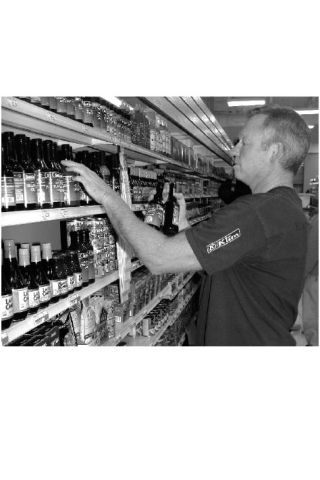 Kern Skinner stocks a selection of sauces at The Ridge Supermarket the week before the store’s opening
