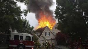 Firefighters deploy to battle a fire that torched the second story of a Snoqualmie home on July 4. Investigators believe a firework caused the blaze.