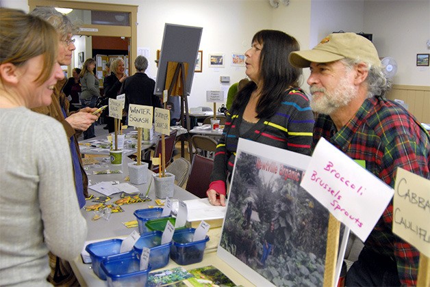 Snoqualmie farmers Jerri and Julie Johnson displayed photos and shared information about farming with visitors at the 2014 Snoqualmie Valley Seed Exchange.