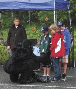 A Trash Ape performance artist meets locals during Fall City Days. Look for these playful creatures on the downtown streets this Saturday.