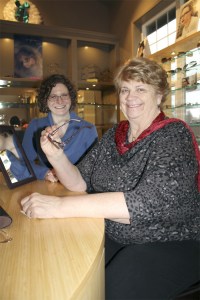 Bev Jorgensen holds a new pair of eyeglasses