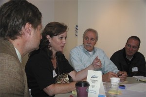 Kim Thomas talks about sharing problem-solving methods at the Key Leaders Summit. Listening are