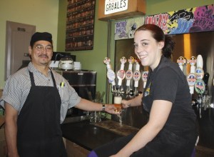 The crew at the Snoqualmie Brewery taproom fill a glass of Meadowbrook Farm ale