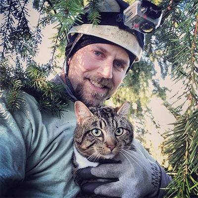 Shaun Sears holds onto the recently rescued Bruce for a photo. Bruce was more interested in getting on the ground than posing for photos.