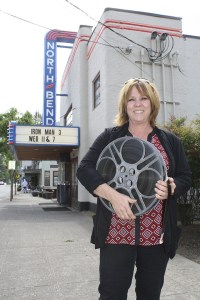 Holding a big 35-mm reel from the theater archives