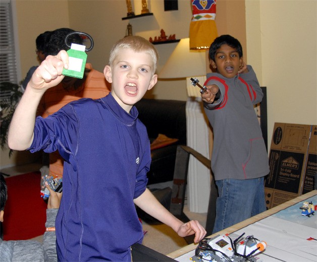 Beau Shain celebrates his robot’s success with picking up a prescription bottle;