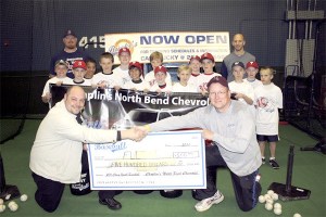 Chaplins North Bend Chevrolet Manager Mike Lawrence shakes hands with Falls Little League coach Brendon van Campen during a clinic with Bucky Jacobsen