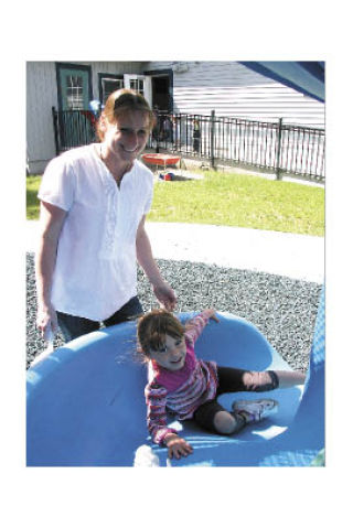 Just 4 Kids Early Learning Center owner Henrietta Cranford smiles as Sarah Long