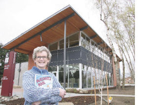 With the peaked roof of the new Fall City Library towering above her