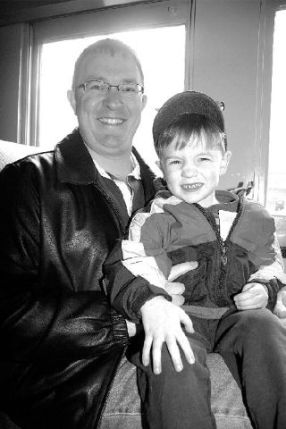 Sitting with his son Owen