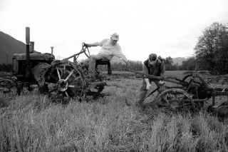 Brothers John Loder of Redmond and Bill Loder of Carnation work to get John’s circa-1920s John Deer tractor off to another lap around the field
