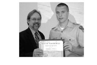 North Bend Mayor Ken Hearing presents Eagle Scout Carter Howell with a certificate of appreciation for his landscaping project