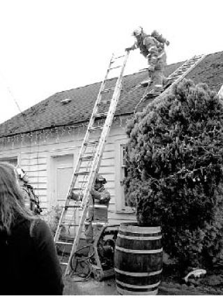 Fall City firefighters extinguish a chimney fire that sparked up in a home at 334th Pl. S.E. in Fall City. Resident Charlotte Noel said she did everything to slow the blaze