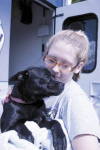 Megan Boulton cradles and kisses her 11-month-old puppy