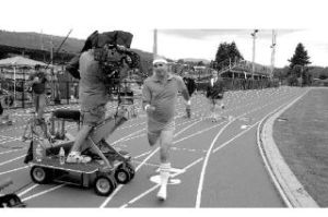 Sweat-band-clad actor Jay Hitt cruises past actors Tim Tracey and Kevin Brady