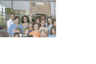 The Eastside chapter of Women of Vision and their children sell lemonade