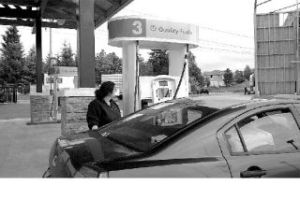 Charlie Fries of Kent fills up her tank at the newly opened Gateway Gas and Deli on Snoqualmie Ridge. Fries said the new station is convenient and was happy with the way the new station blends in with the neighborhood.