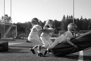 Peewee football campers learn to play rough and tackle their opponents
