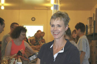 Gail Gergasko pauses for a moment in the midst of Wednesday’s weekly food distribution at the Mount Si Helping Hand Food Bank. She plans to continue her volunteer work through special food bank projects.
