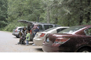 Morgan Logan changes into hiking boots in preparation for a day hike at Twin Falls with her daughters
