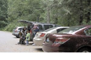 Morgan Logan changes into hiking boots in preparation for a day hike at Twin Falls with her daughters