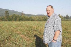 Valley resident and biologist Harold Erland approaches a herd of elk at Meadowbrook Farm. Erland