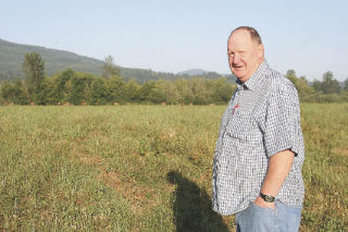 Valley resident and biologist Harold Erland approaches a herd of elk at Meadowbrook Farm. Erland